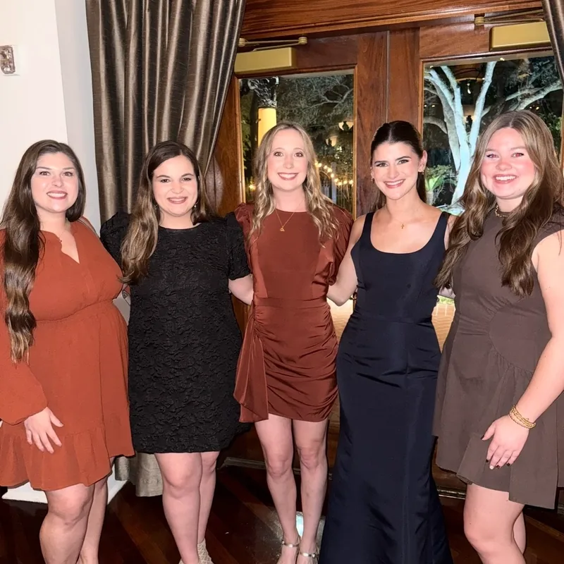 Dr. Hannah Butler with friends at a formal gathering