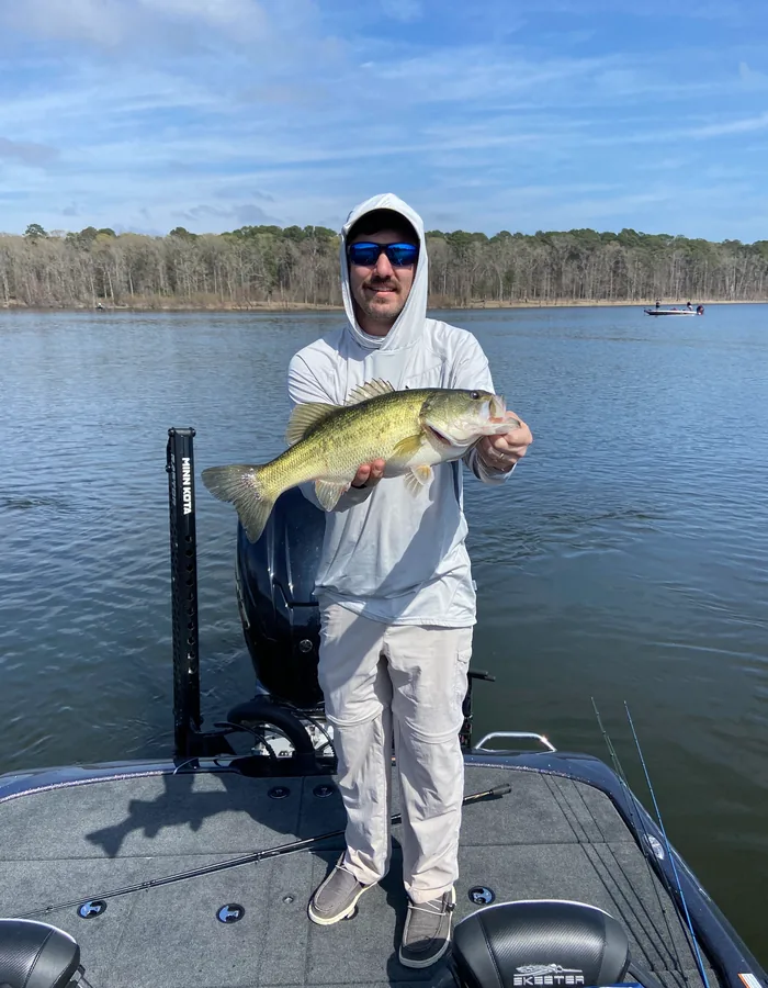 Dr. James Wilbert Marcantel Jr. holding a fish on a fishing trip