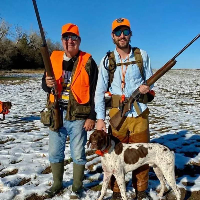 Dr. James Wilbert Marcantel Jr. on a hunting trip with a friend and their dog