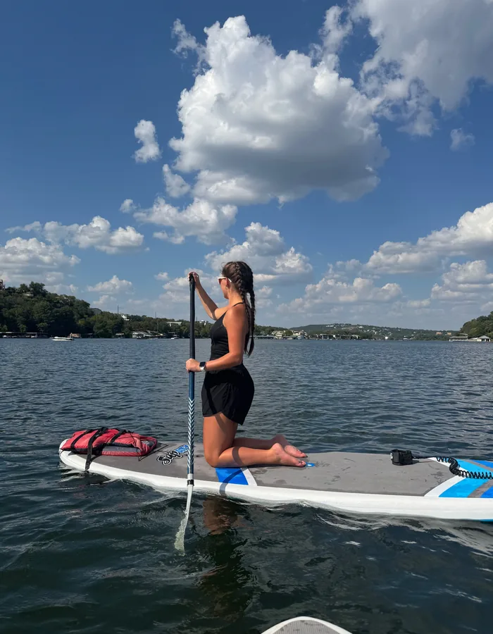 Karleigh Nunez paddleboarding on a lake