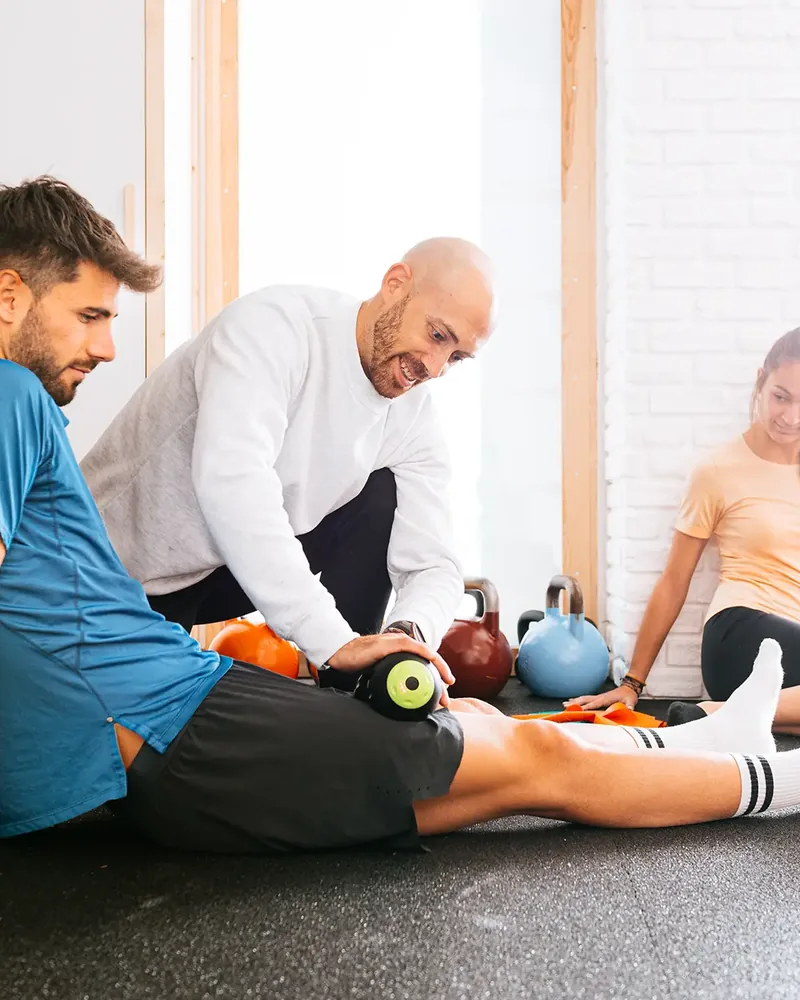 Therapist guiding a patient through a hip and knee strengthening exercise at Hope Therapy Center