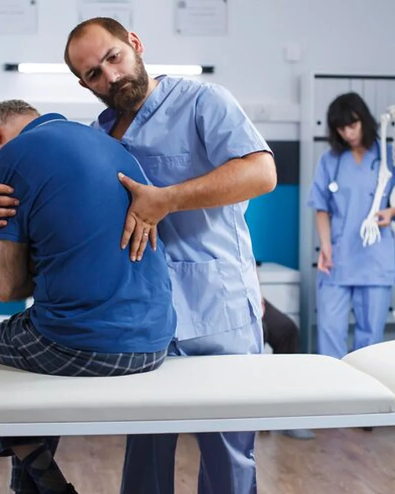 Licensed physical therapist assessing a patient's knee during orthopedic therapy in Lake Charles
